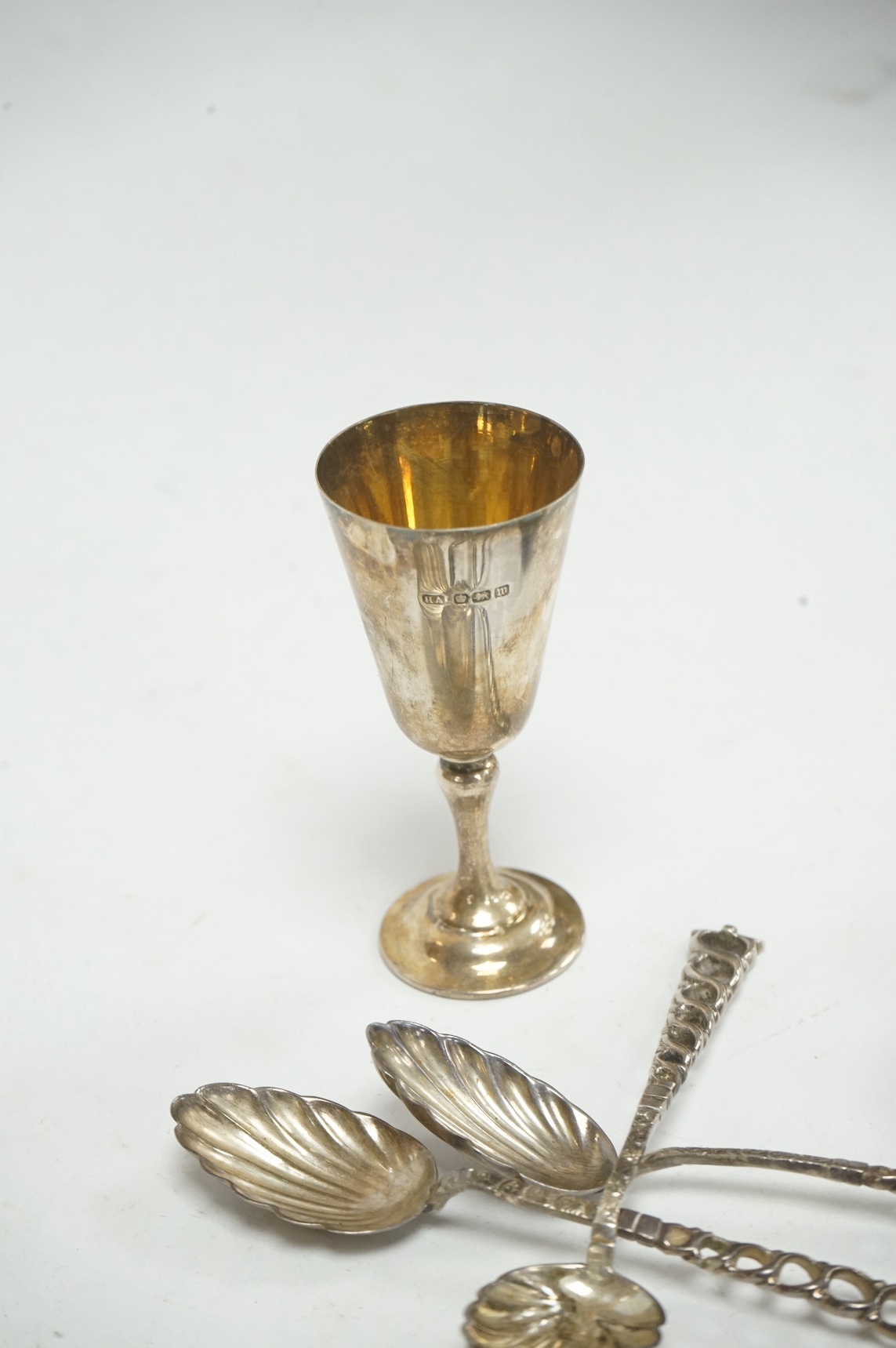 A set of six late Victorian silver teaspoons, with pierced ring handles and shell bowls, Stokes & Ireland, Birmingham, 1890, 11.1cm, together with a silver condiment spoon, two pair of 19th century silver sugar tongs, a